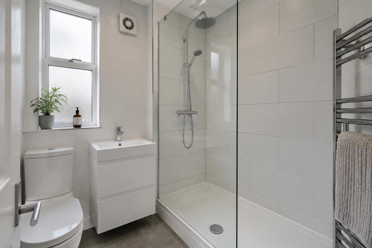 Illustrative image of a newly fitted shower room in a converted UK flat